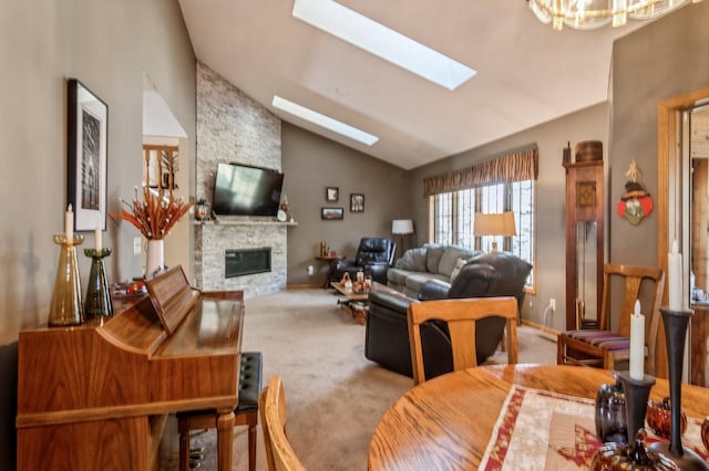 carpeted living room featuring lofted ceiling, a stone fireplace, and a chandelier