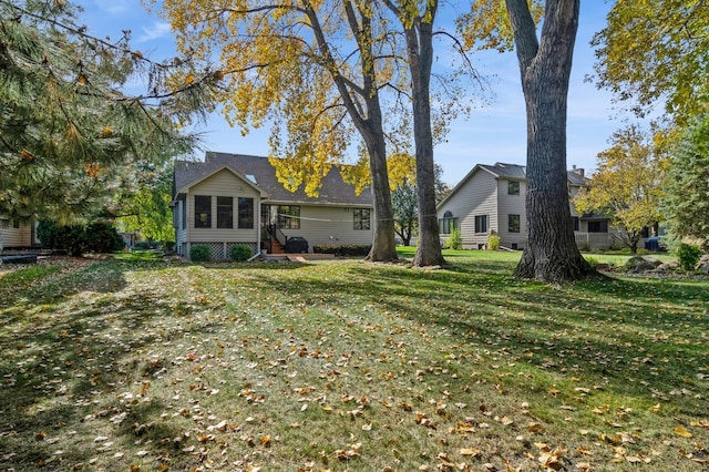 rear view of property with a yard