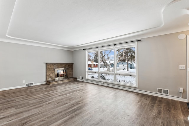 unfurnished living room featuring a fireplace and dark hardwood / wood-style floors