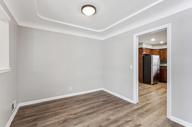 empty room with hardwood / wood-style floors