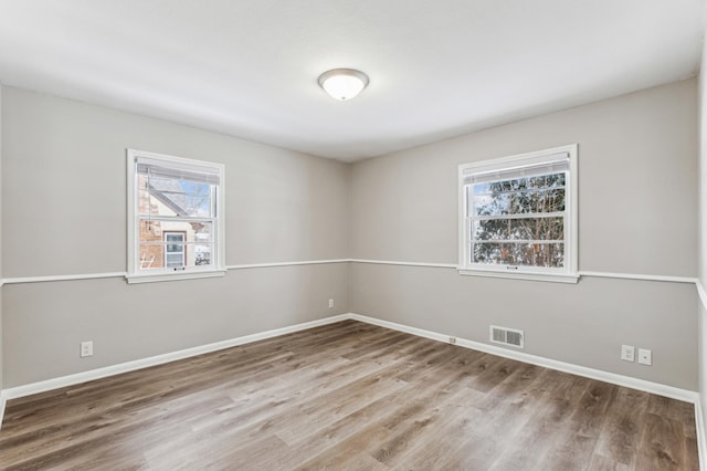 unfurnished room with wood-type flooring