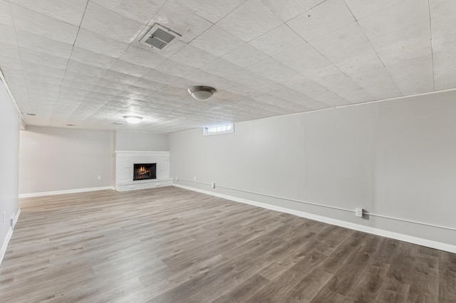 basement featuring a fireplace and hardwood / wood-style flooring