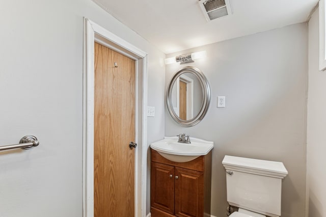 bathroom with toilet and vanity