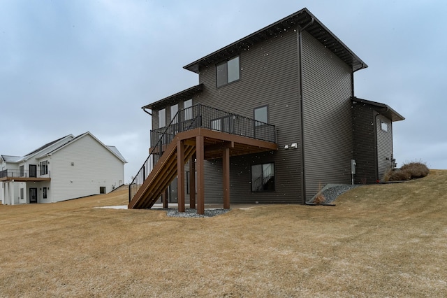 back of house featuring a deck and a yard