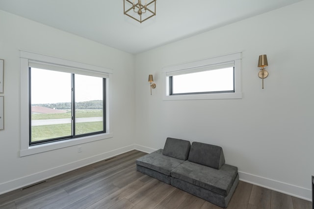 sitting room featuring a chandelier, visible vents, dark wood finished floors, and baseboards