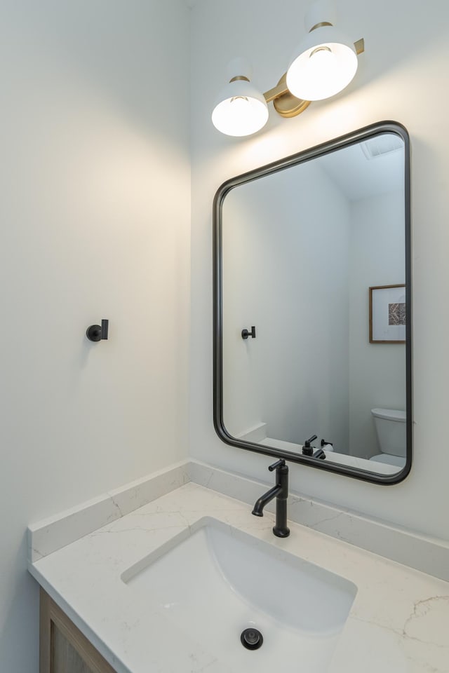 bathroom featuring vanity and toilet