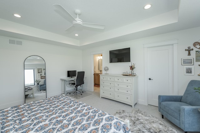 bedroom featuring a tray ceiling and baseboards