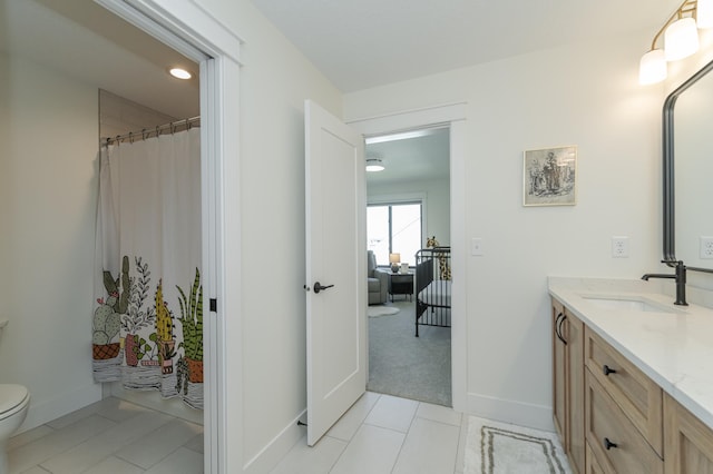 full bath with baseboards, vanity, toilet, and tile patterned floors