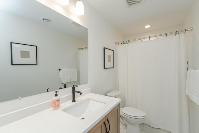 bathroom with toilet, vanity, visible vents, and recessed lighting