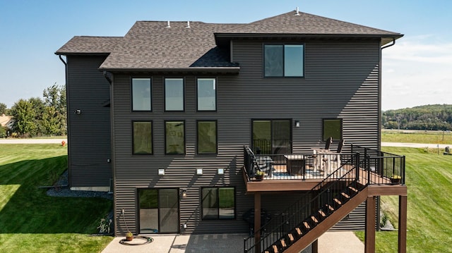 back of property featuring a yard, a shingled roof, stairway, a patio area, and a wooden deck