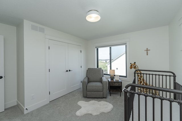 bedroom featuring light colored carpet, a closet, visible vents, and baseboards