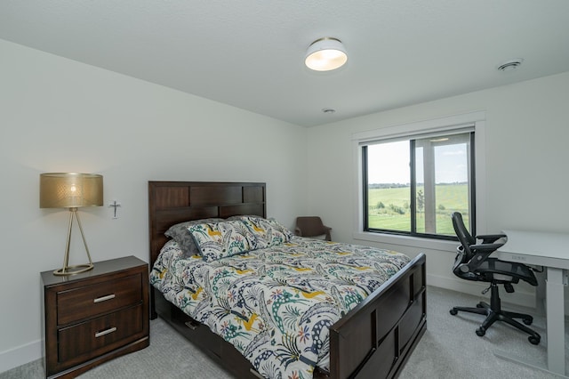 bedroom with light carpet, visible vents, and baseboards