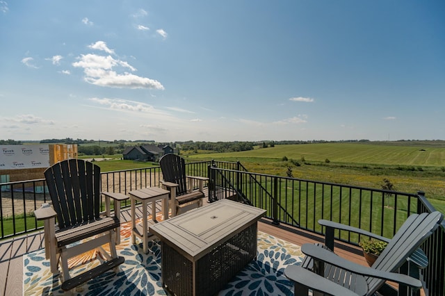 deck featuring a yard and a rural view