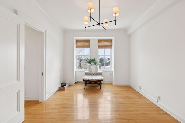 unfurnished dining area with light hardwood / wood-style flooring, crown molding, and a notable chandelier