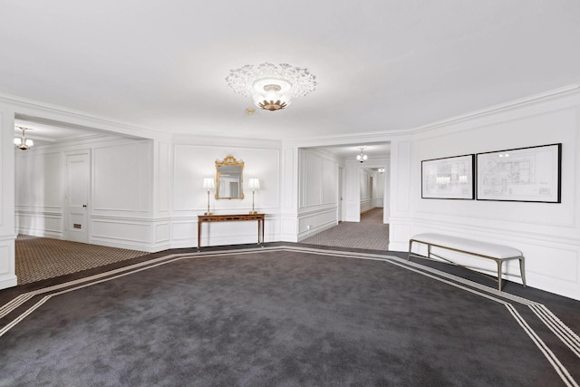 empty room featuring carpet and ornamental molding