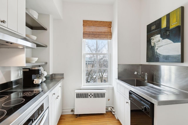 510 Groveland Ave Unit 502, Minneapolis, MN 55403 - kitchen with stainless steel counters, open shelves, black appliances, and radiator heating unit