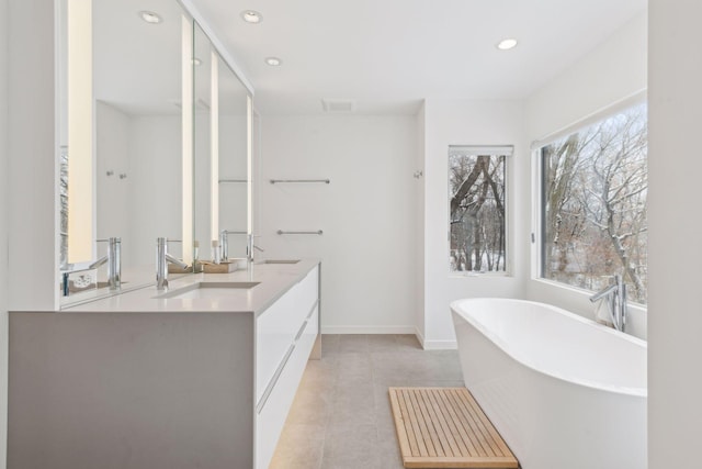 bathroom with vanity, tile patterned flooring, and a bathing tub