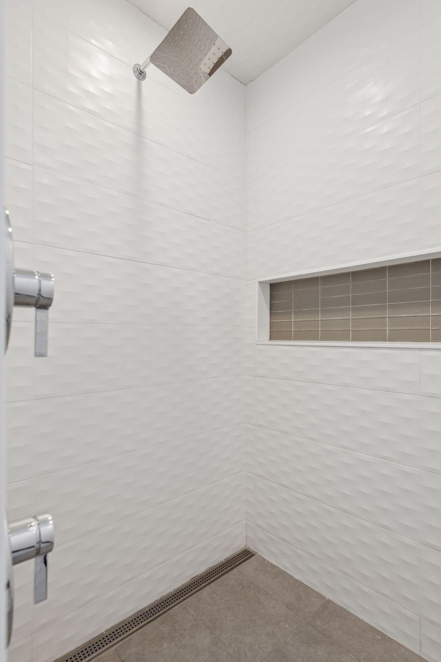 bathroom with tiled shower