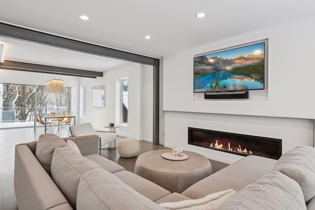 living room with beam ceiling and wood-type flooring