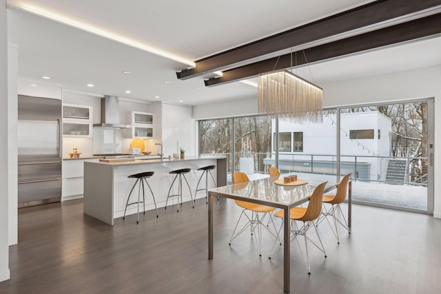 dining space featuring sink, dark wood-type flooring, and plenty of natural light