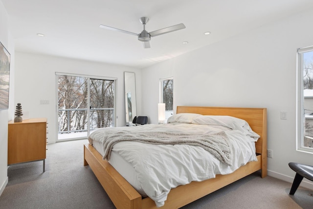 bedroom with access to outside, ceiling fan, carpet flooring, and multiple windows