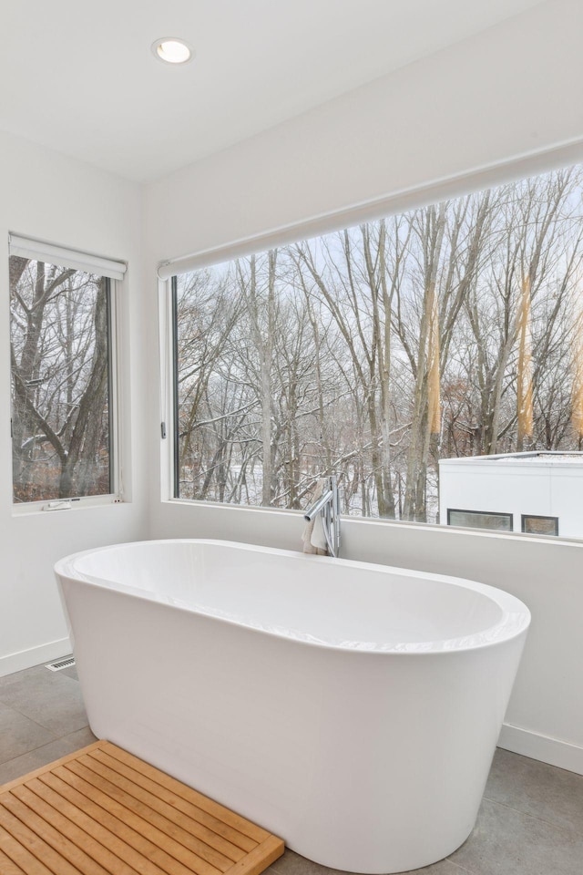 bathroom featuring tile patterned flooring and a bathtub