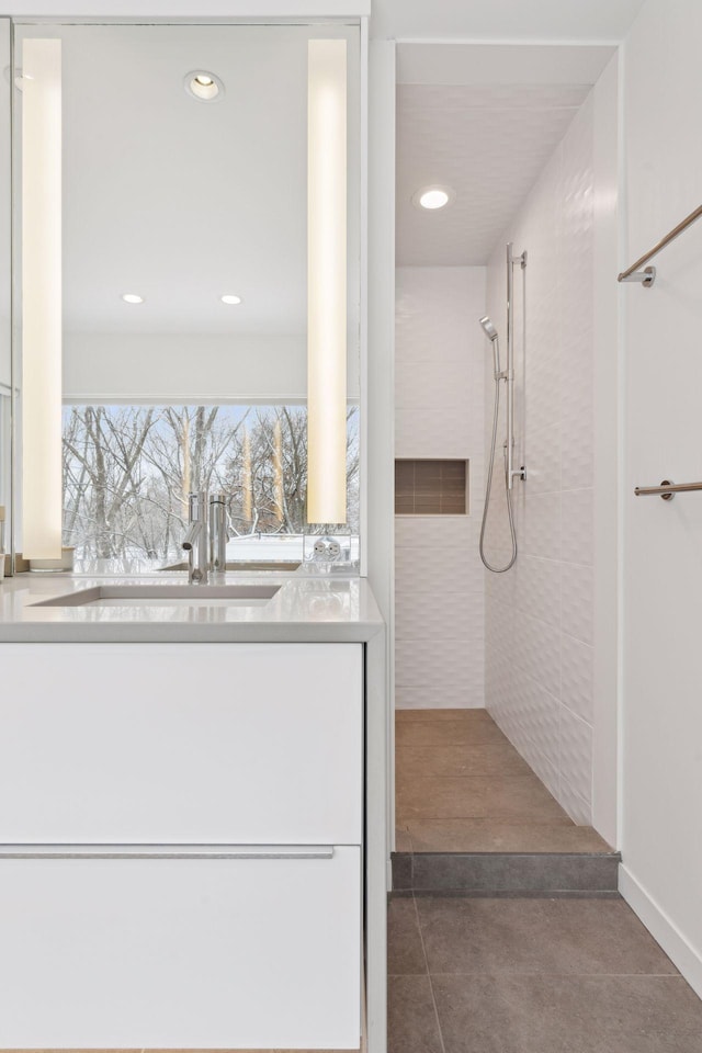 bathroom with sink and tiled shower