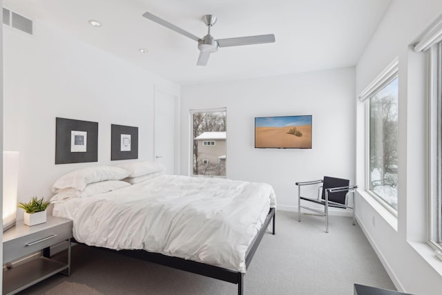 bedroom with ceiling fan and light carpet