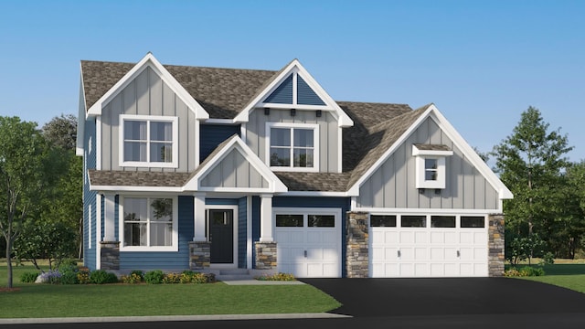 view of front of property featuring a garage and a front lawn