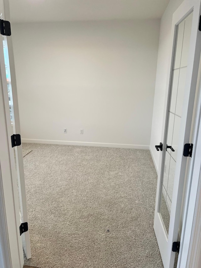 spare room with carpet flooring and french doors