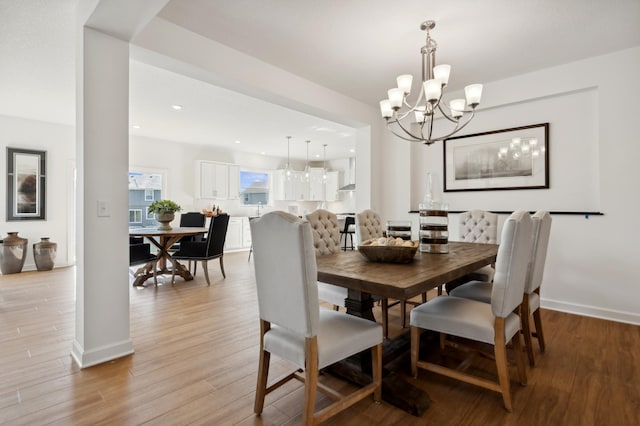 dining room featuring light hardwood / wood-style floors and a notable chandelier