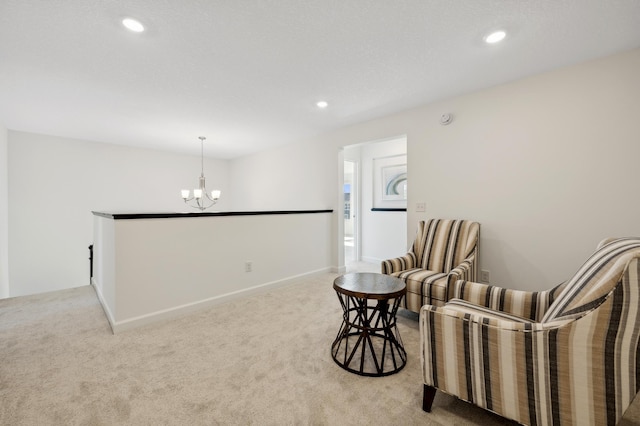 living area featuring light carpet and a chandelier