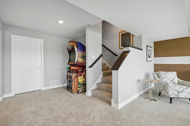 stairs featuring carpet flooring