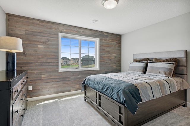 carpeted bedroom with wood walls