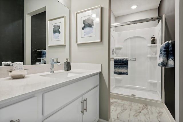 bathroom featuring vanity and an enclosed shower