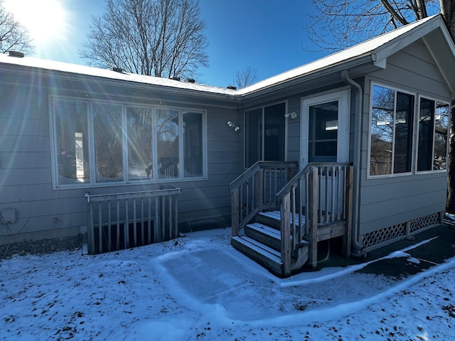 view of snow covered property entrance