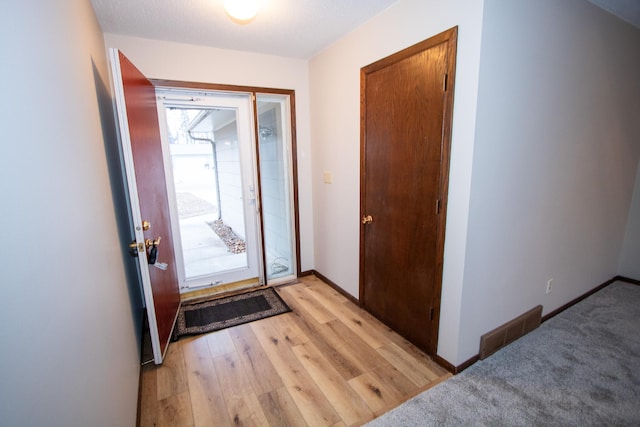 foyer with light colored carpet