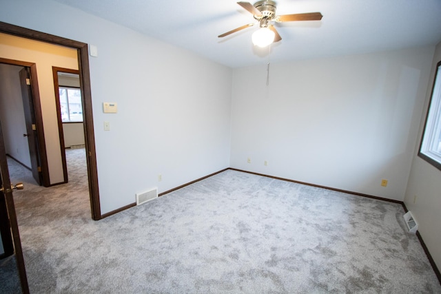 carpeted empty room with ceiling fan