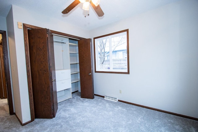 unfurnished bedroom with ceiling fan, a closet, and light colored carpet