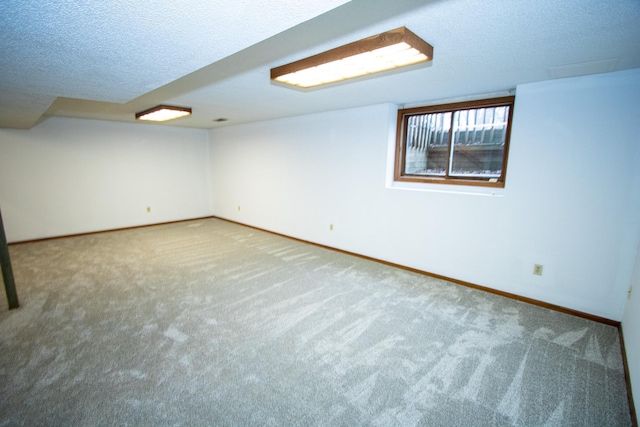 basement featuring carpet floors and a textured ceiling