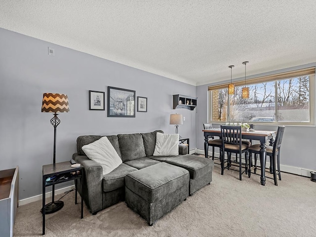 living room featuring a baseboard radiator, carpet flooring, and a textured ceiling