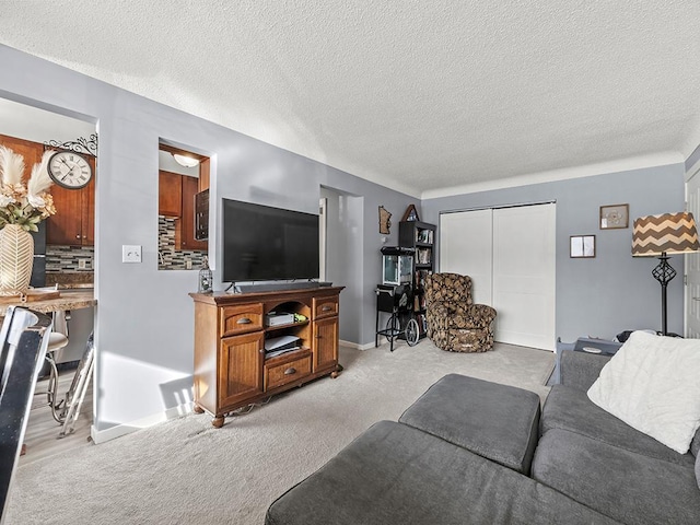 carpeted living room featuring a textured ceiling