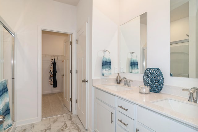 bathroom with walk in shower and vanity