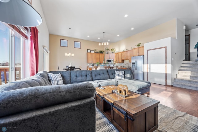 living room with sink, hardwood / wood-style floors, and a notable chandelier