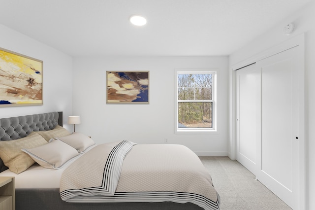 bedroom featuring a closet and light colored carpet