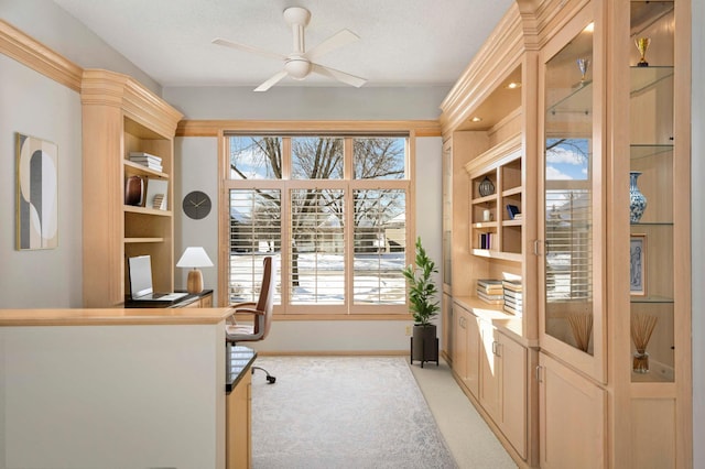 home office featuring a ceiling fan, light carpet, and baseboards