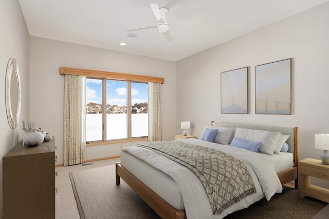 bedroom with ceiling fan, carpet floors, and baseboards