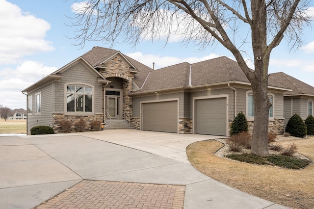 view of front of property with stone siding, concrete driveway, roof with shingles, and an attached garage