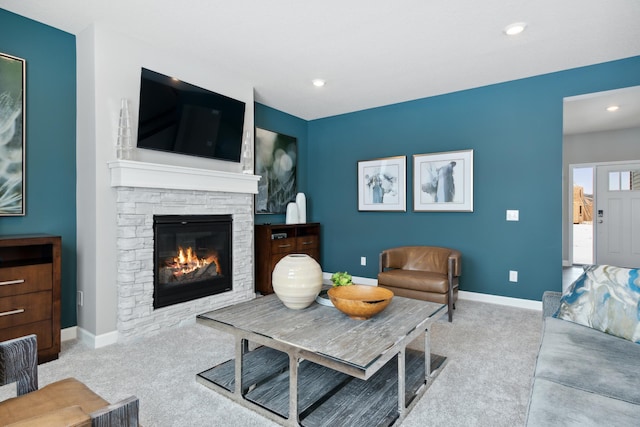 living room with a fireplace and light carpet