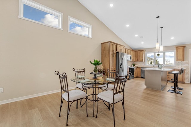 2834 Meadowview Ln NE, Owatonna, MN 55060 - dining space featuring light wood-style floors, recessed lighting, high vaulted ceiling, and baseboards